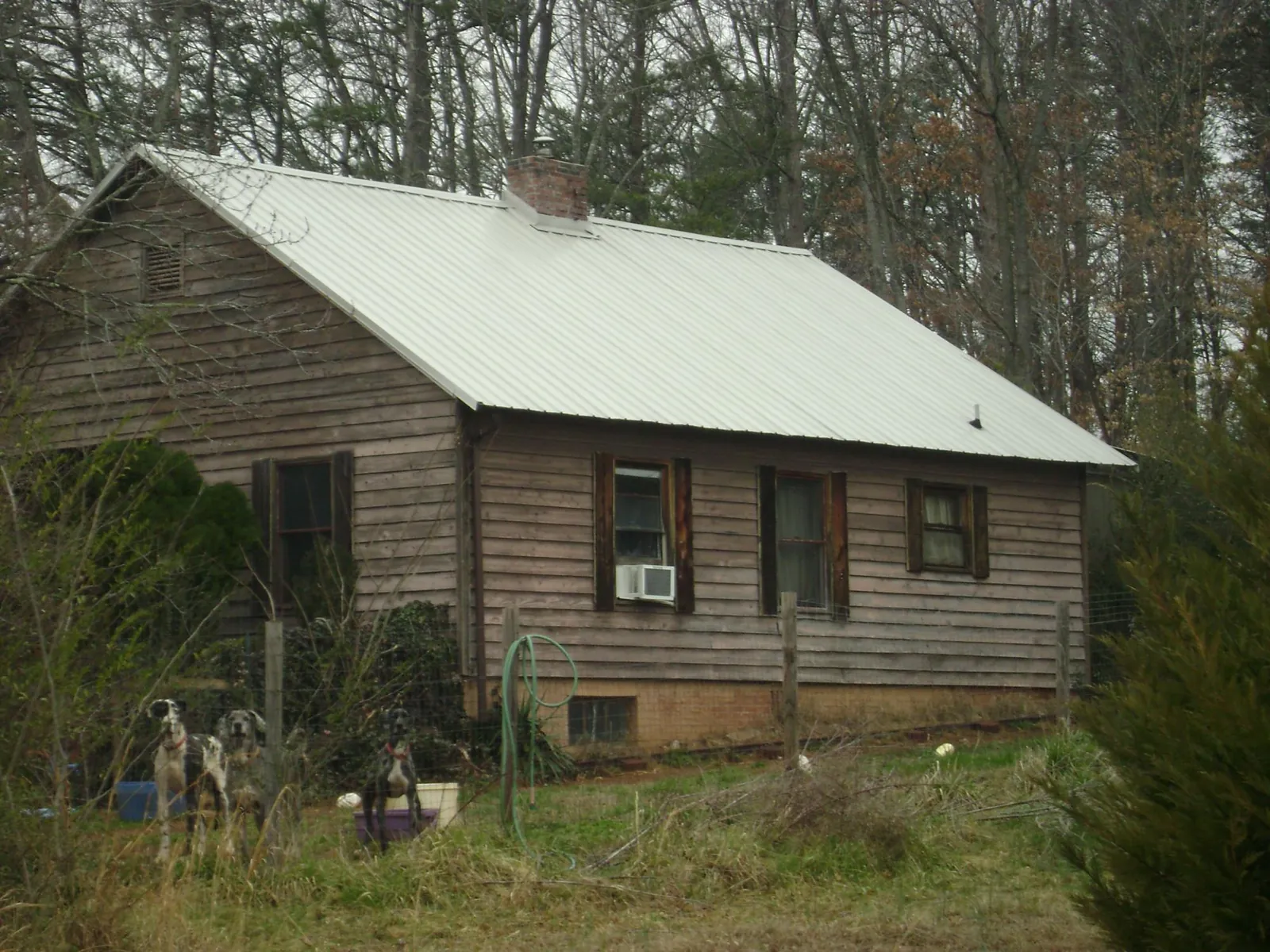 White metal roof on an old wood sided farmhouse, from a Metal Roof Installation job in Cherryville